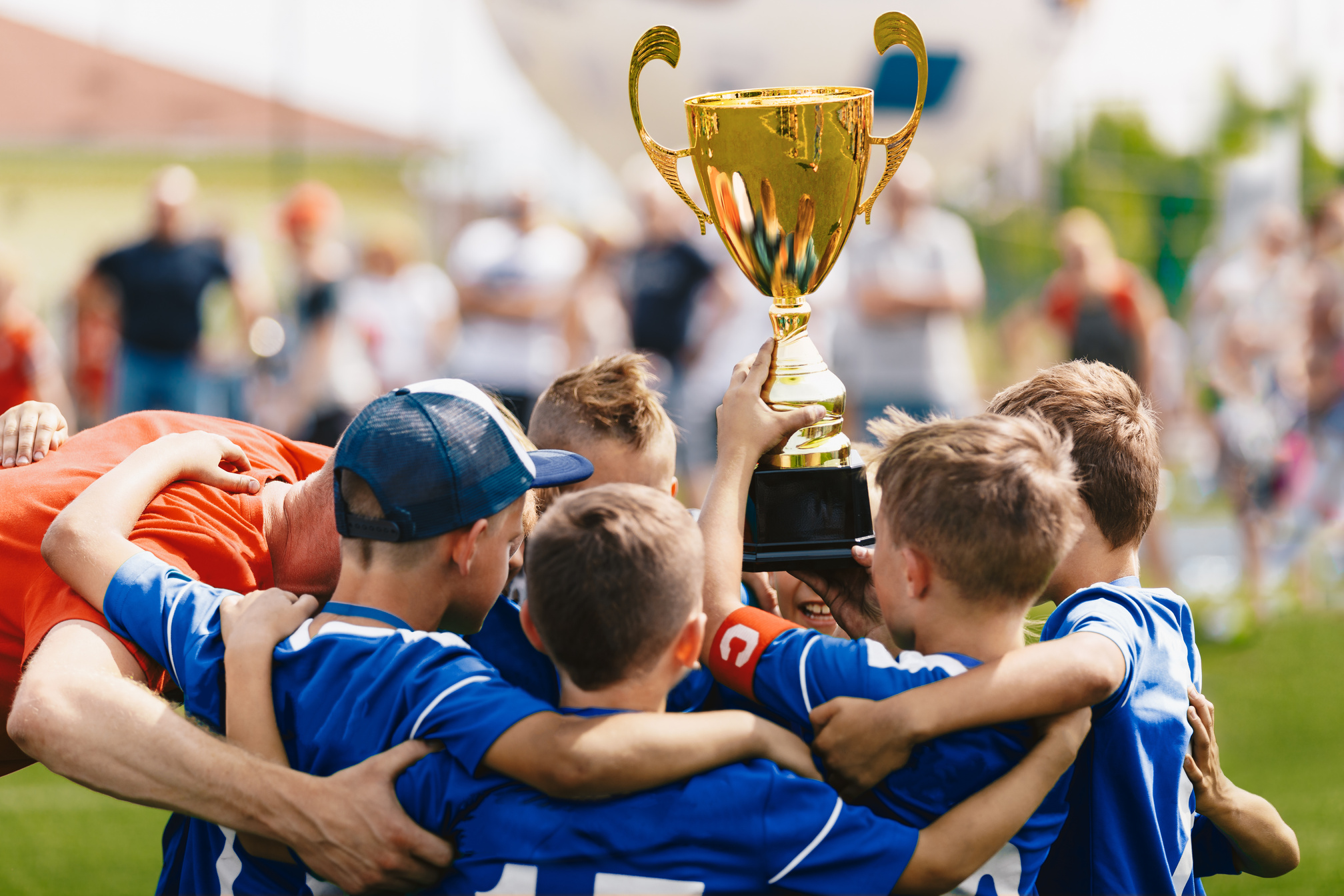 Team of Winning Football Players Holding a Trophy